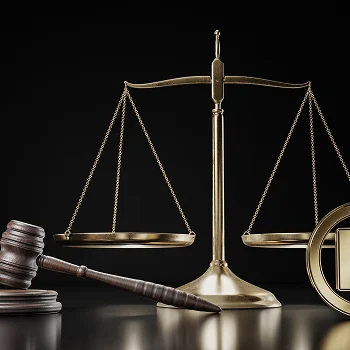 A golden balance scale with a registered trademark symbol on one side, set against a black background.